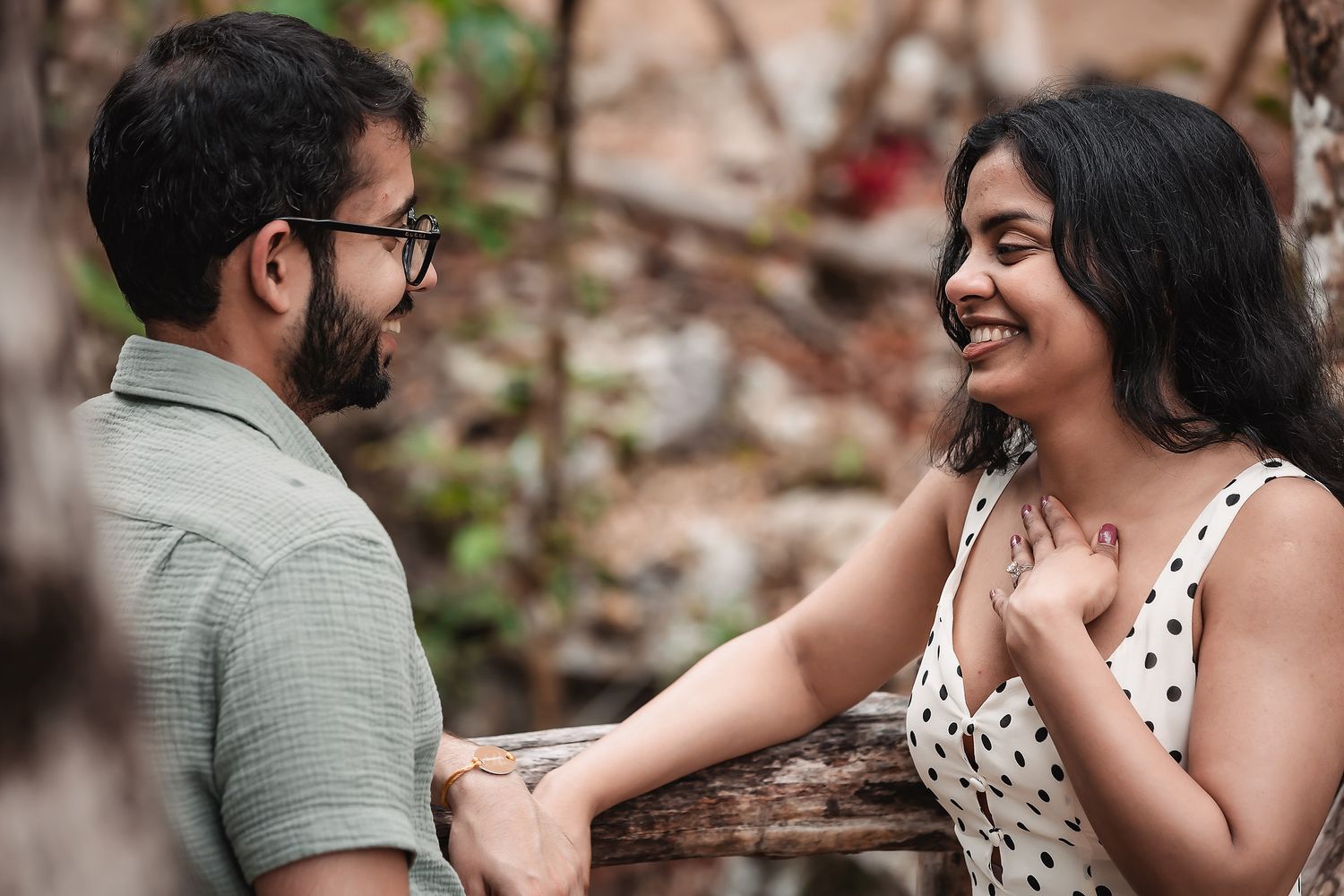 A couple shares playful moments and laughter during an outdoor photoshoot.