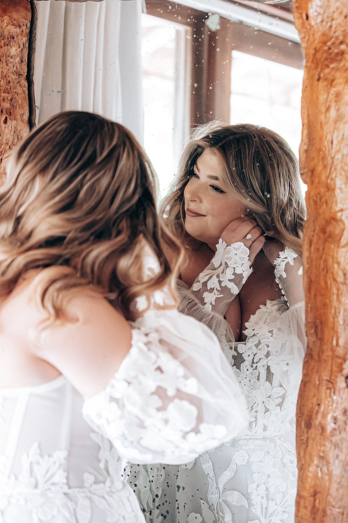 Sequence of shots near rustic wooden beams showing a white lace dress in natural light.