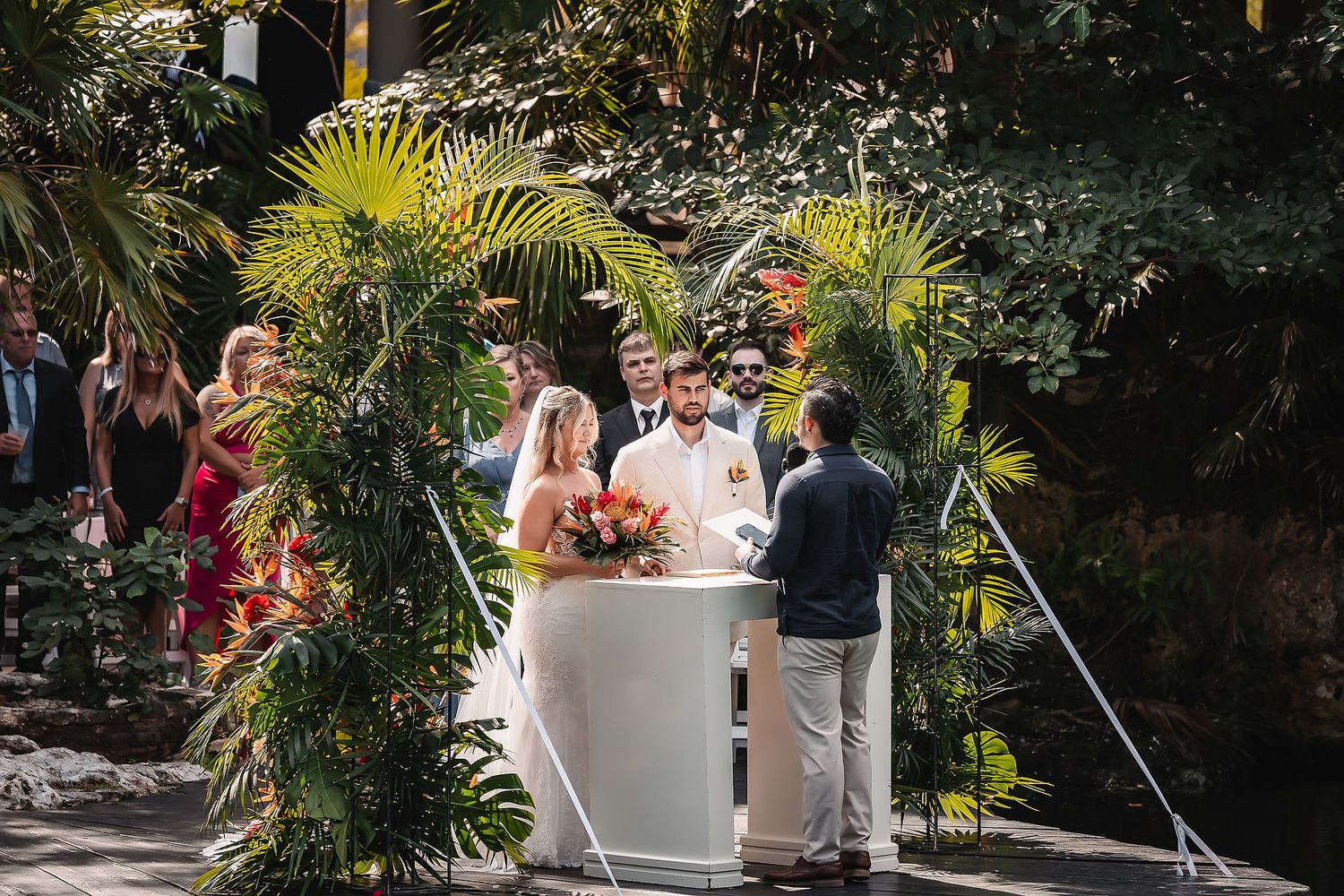 Tropical garden wedding venue with stone pathways and lush landscaping.