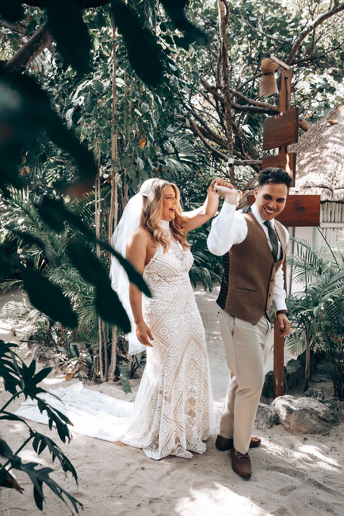Candid wedding moments captured in a natural garden setting with dappled sunlight.