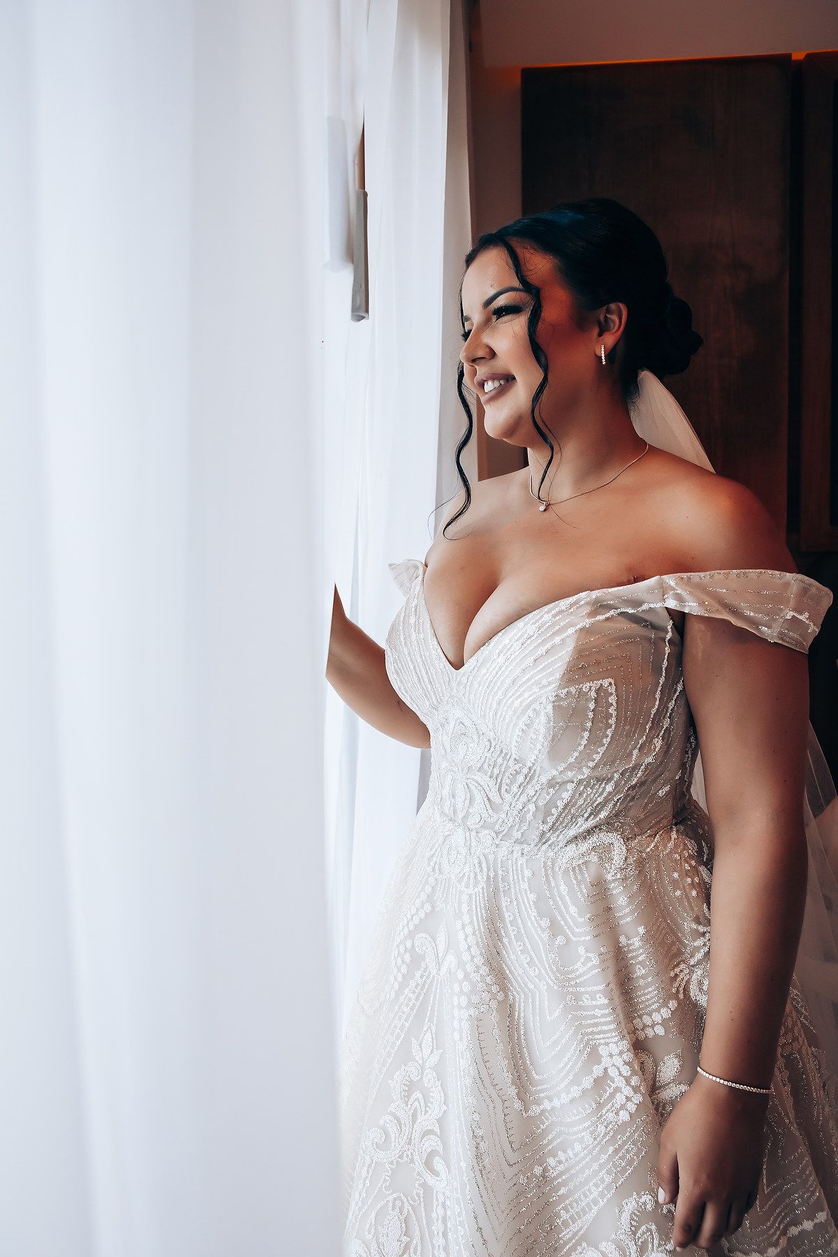 Elegant white lace wedding dress with intricate beading and strapless design.