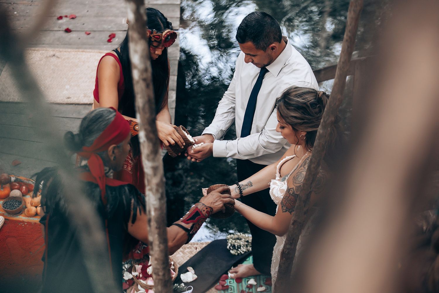 A mystical wedding ceremony takes place in a forest setting with spiritual elements and red decorative details.
