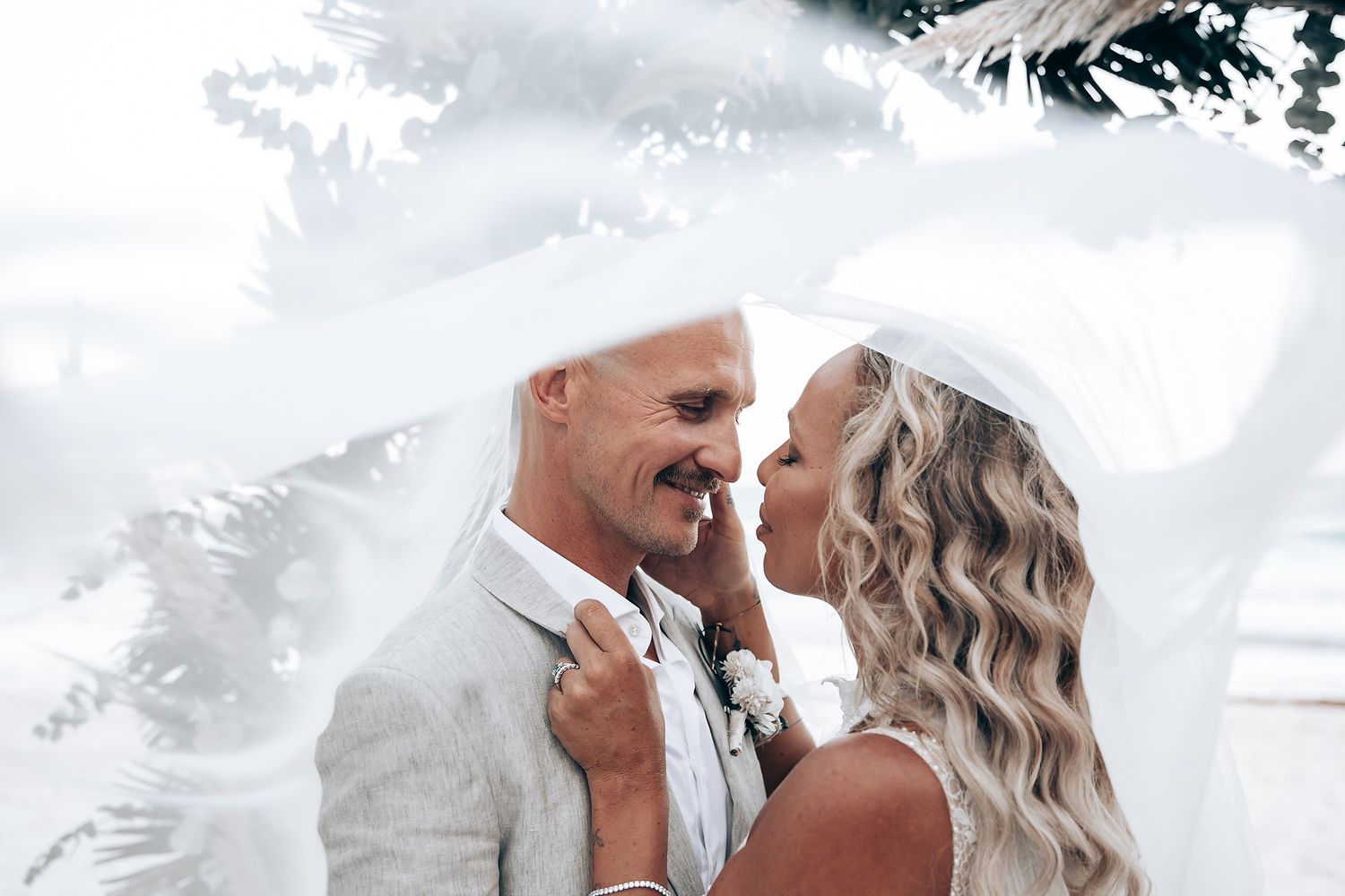 An intimate beach wedding moment captured against the ocean backdrop.