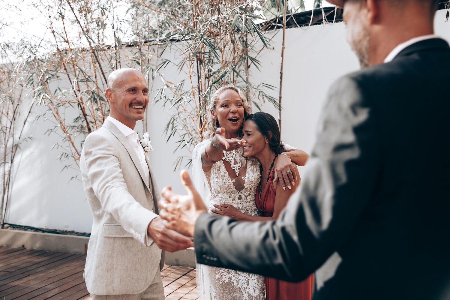 Candid emotional moments captured during a wedding celebration with guests in formal attire.