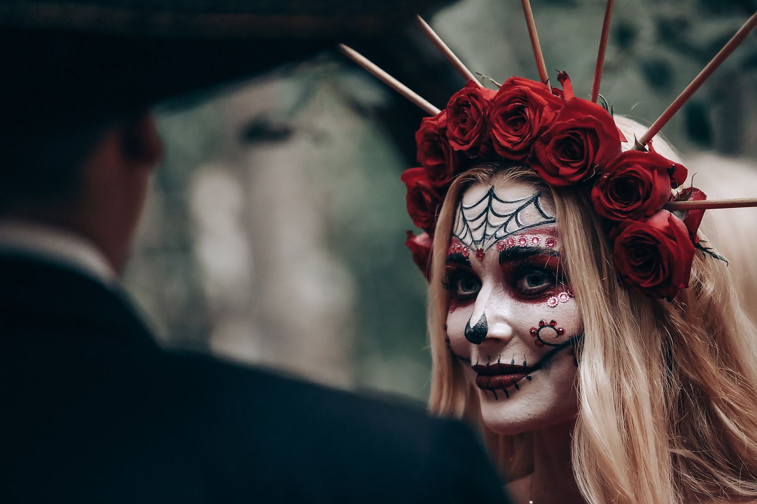Dark gothic makeup and red rose crown create haunting Halloween aesthetic.