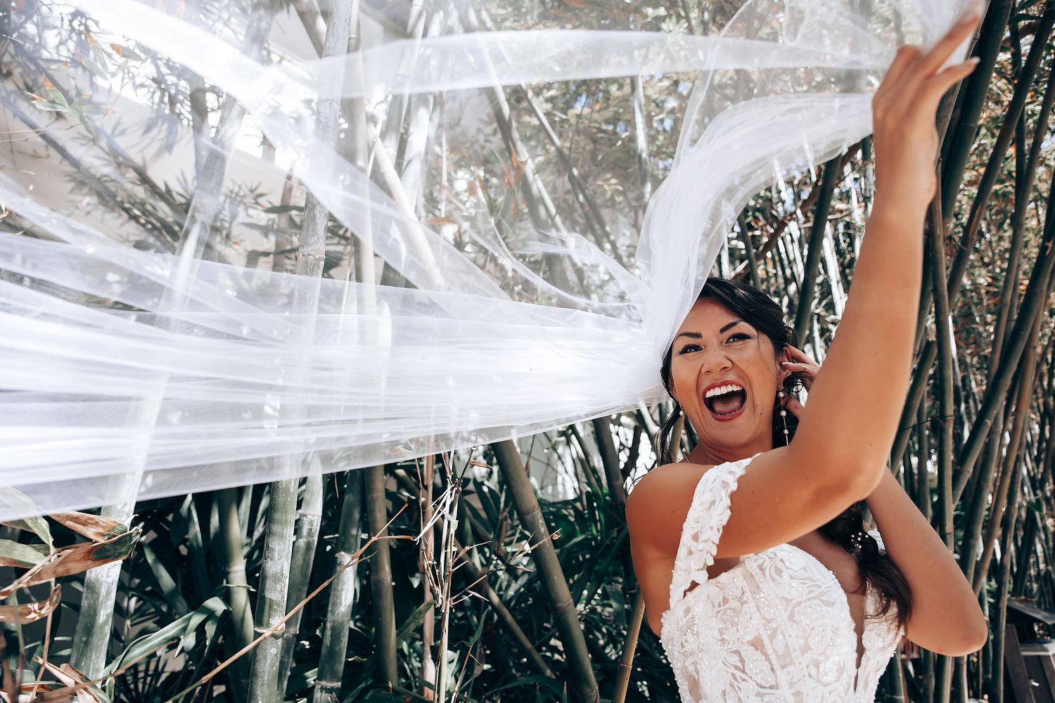 Flowing white fabric and decorative elements creating an ethereal outdoor wedding setting.