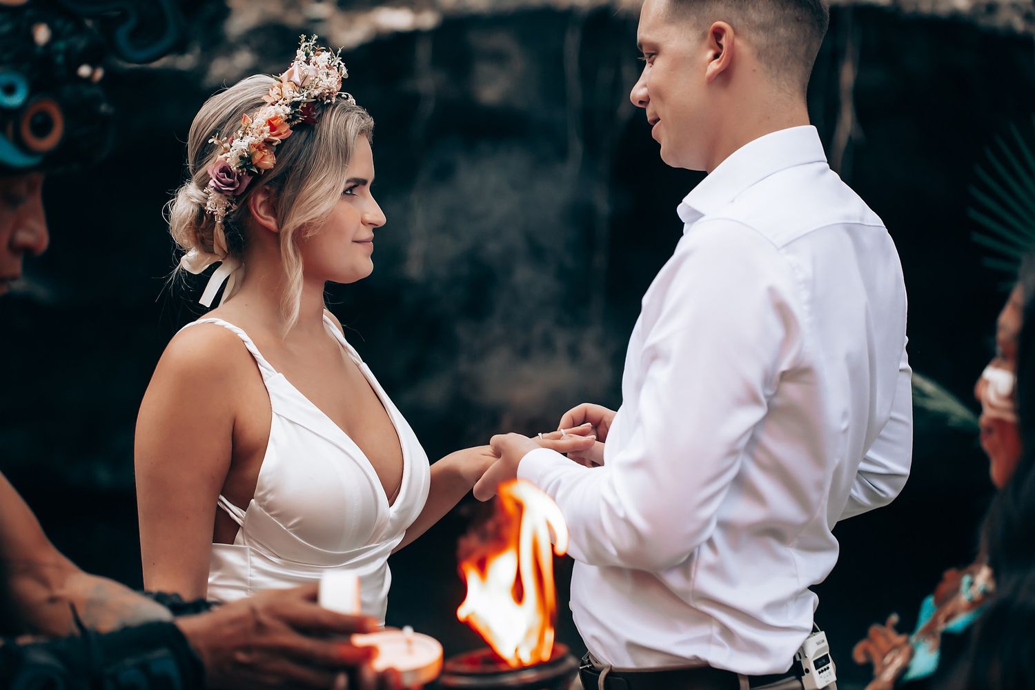 Couple dancing together at an outdoor evening wedding reception with warm lighting and festive atmosphere.