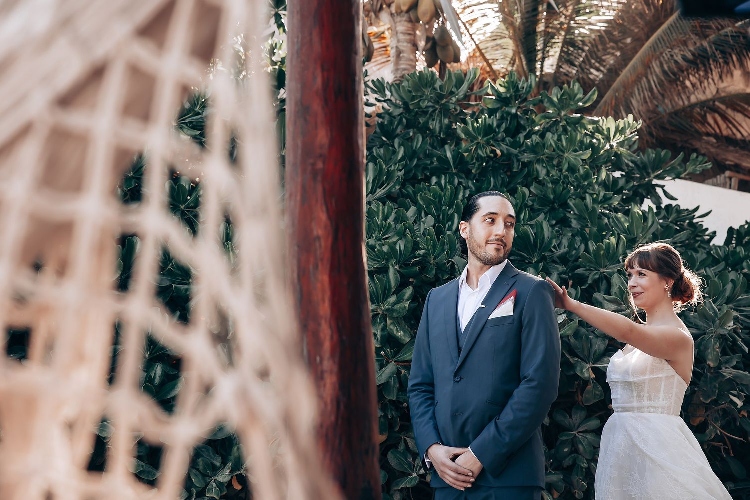 Elegant wedding couple shares intimate moments in a lush garden setting during their special day celebration.