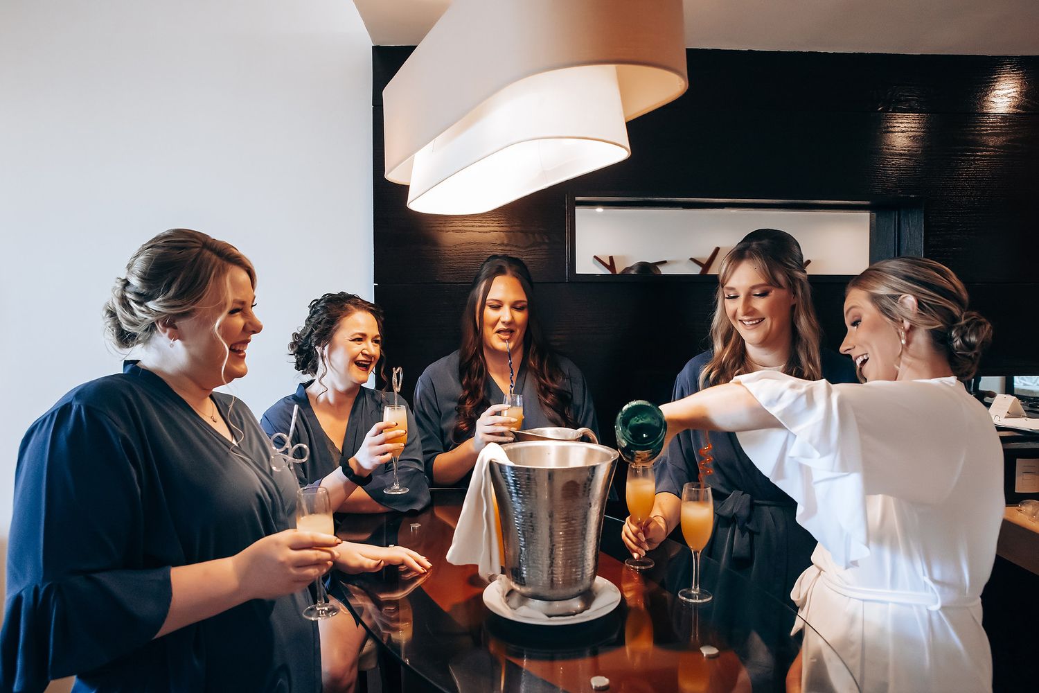 A group of friends enjoying drinks and socializing in a cozy indoor setting.