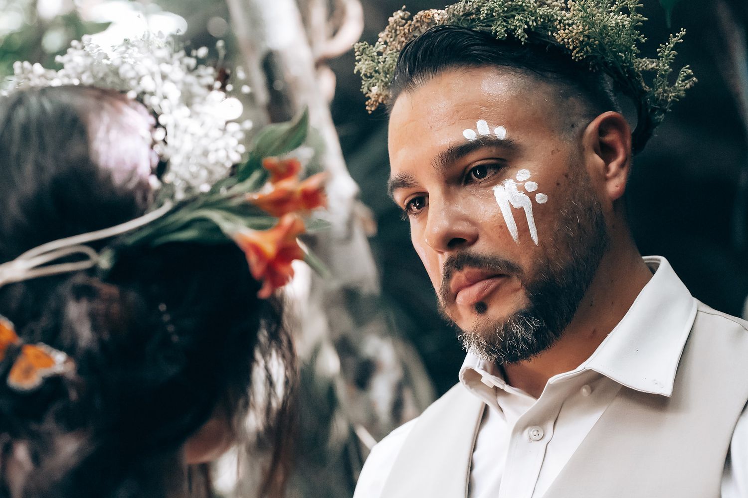 Intimate outdoor gathering with smoke effects and natural lighting in a forest setting.
