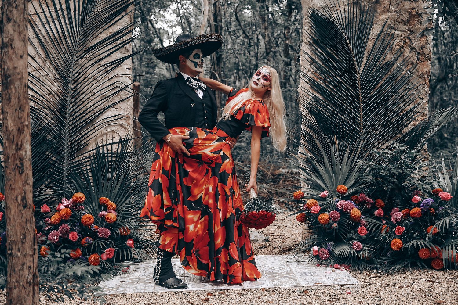 Dancers perform an artistic routine among palm fronds and trees in a natural setting.