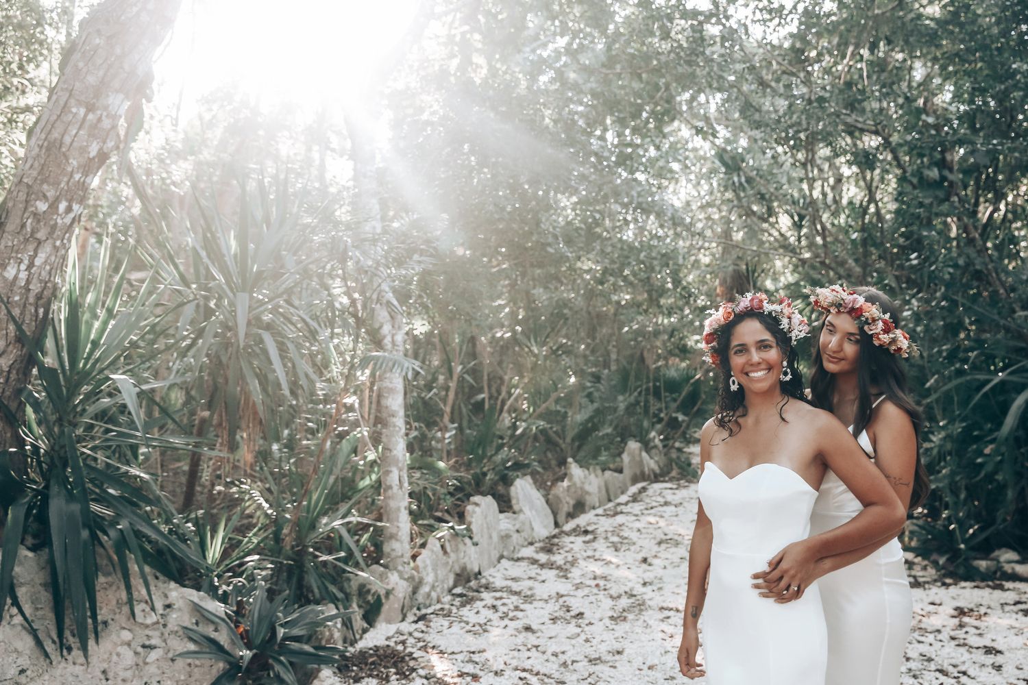Sunlit outdoor celebration in a verdant garden setting with natural light streaming through trees.