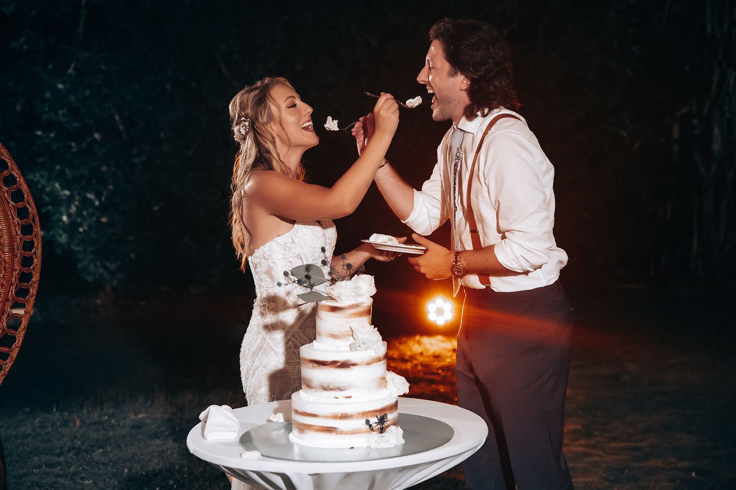 Couple shares romantic dance moments during evening wedding reception.