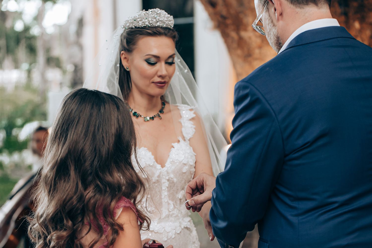 A couple shares an intimate moment during their wedding ceremony while exchanging rings.