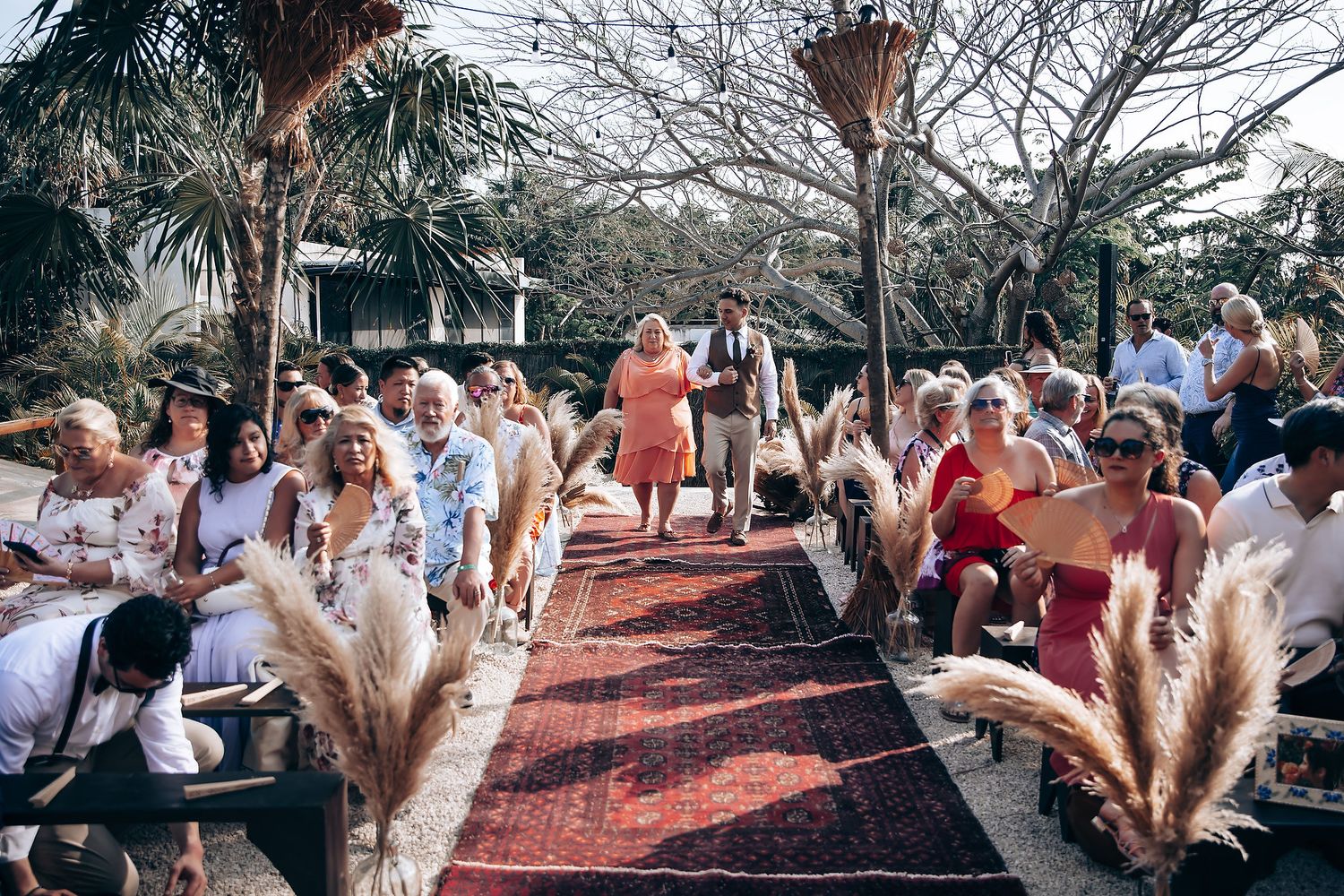 A series of outdoor wedding celebration photos showing guests dancing and celebrating on a brick patio area.