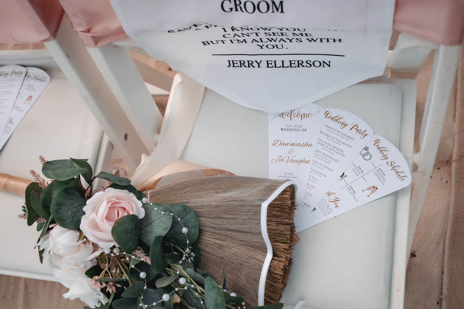 Wedding flat lay with floral bouquet, fan program, and groom chair sign reading Jerry Ellerson.