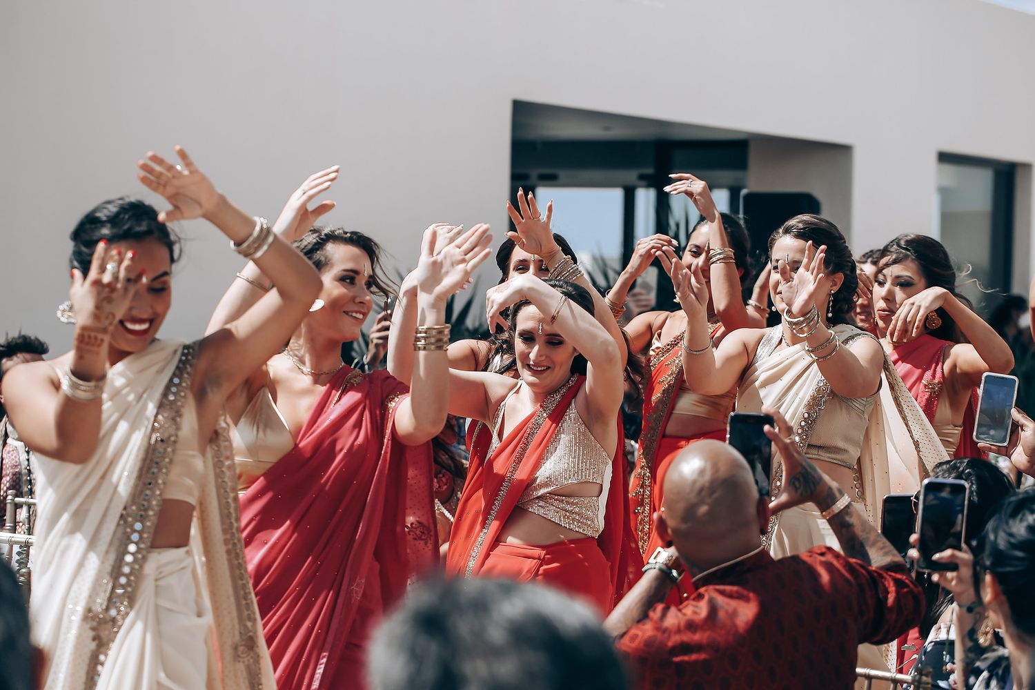 Excited wedding guests cheering and clapping during a celebration.