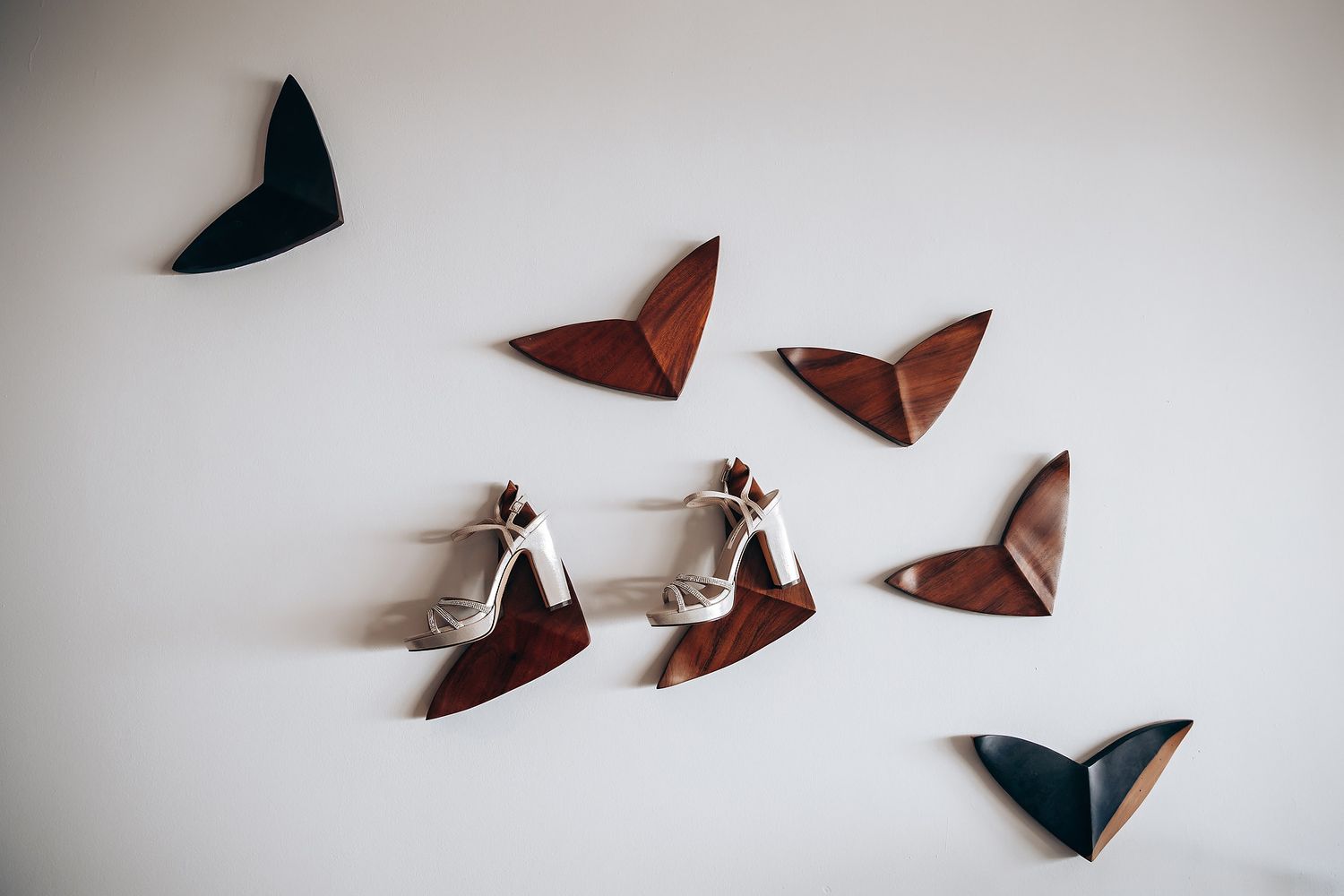 A sequence of origami paper cranes in various stages of folding shown from start to finish against a white background.