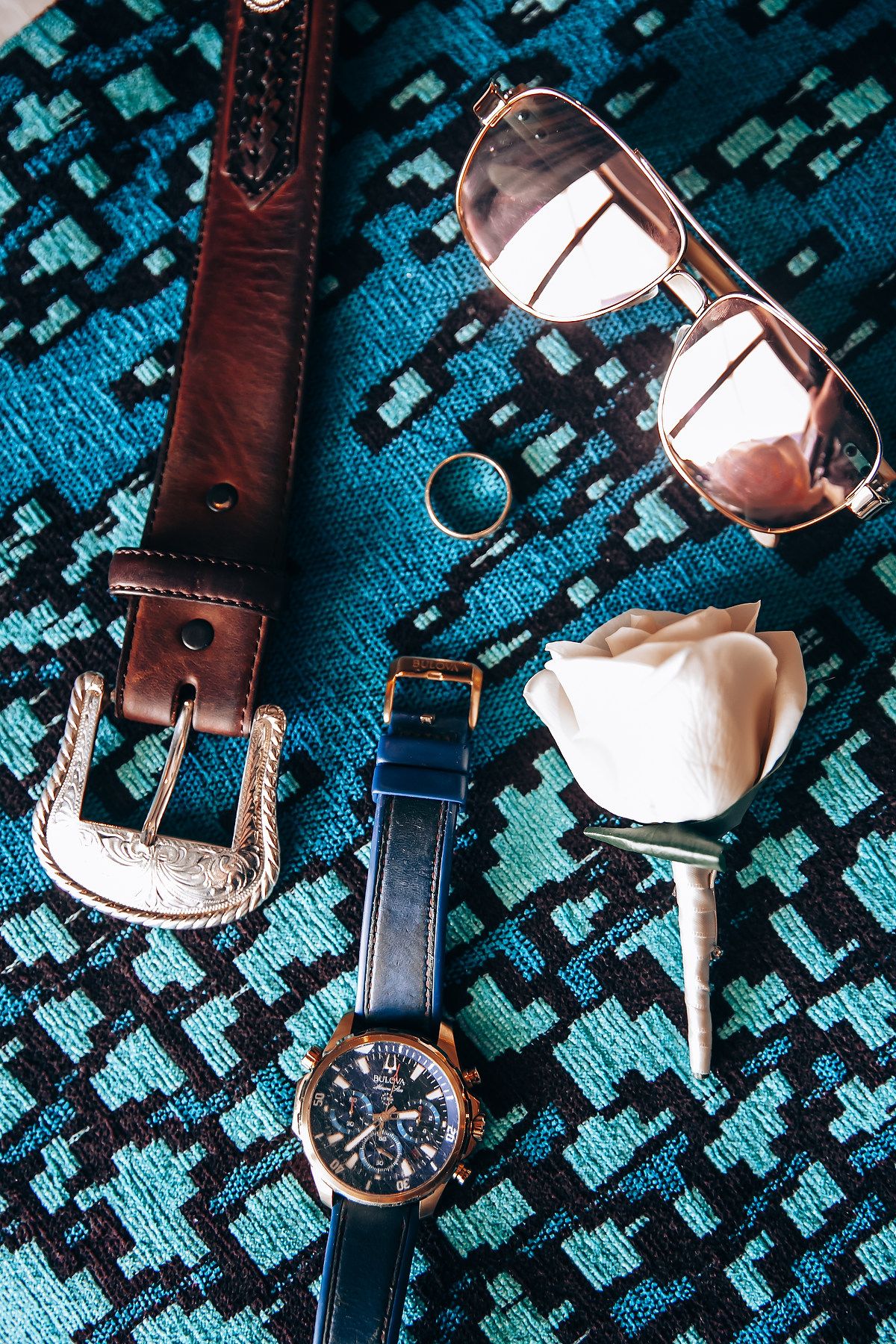 Close-up detail shots of leather watch straps and timepieces on a textured blue-green surface.