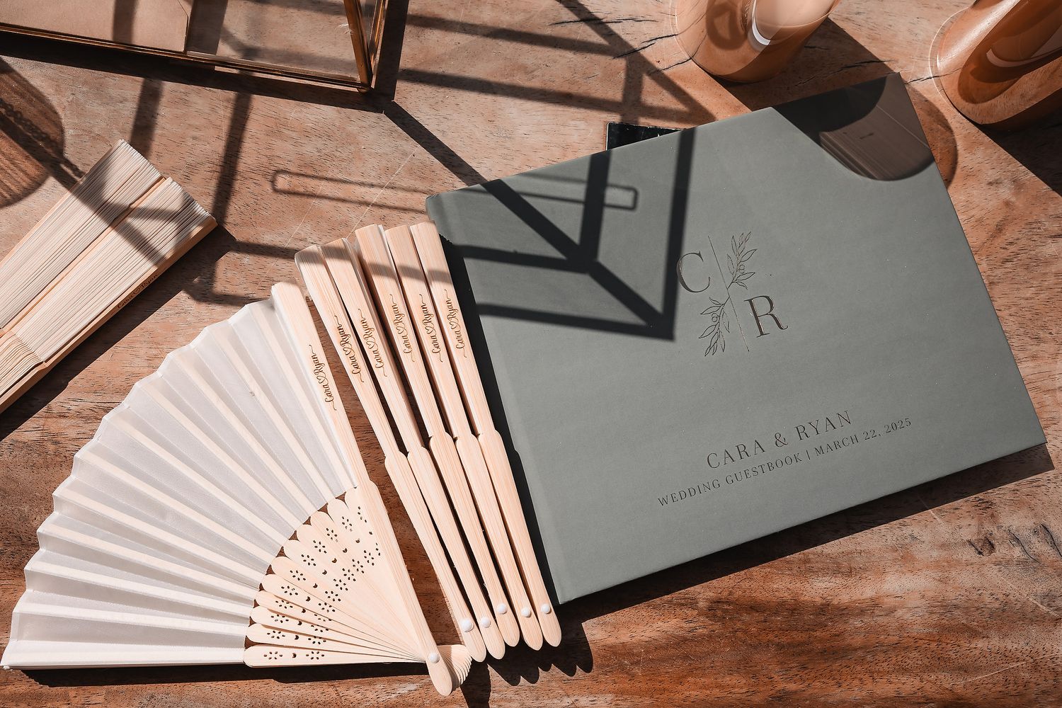Collection of decorative paper fans displayed at a wedding venue.