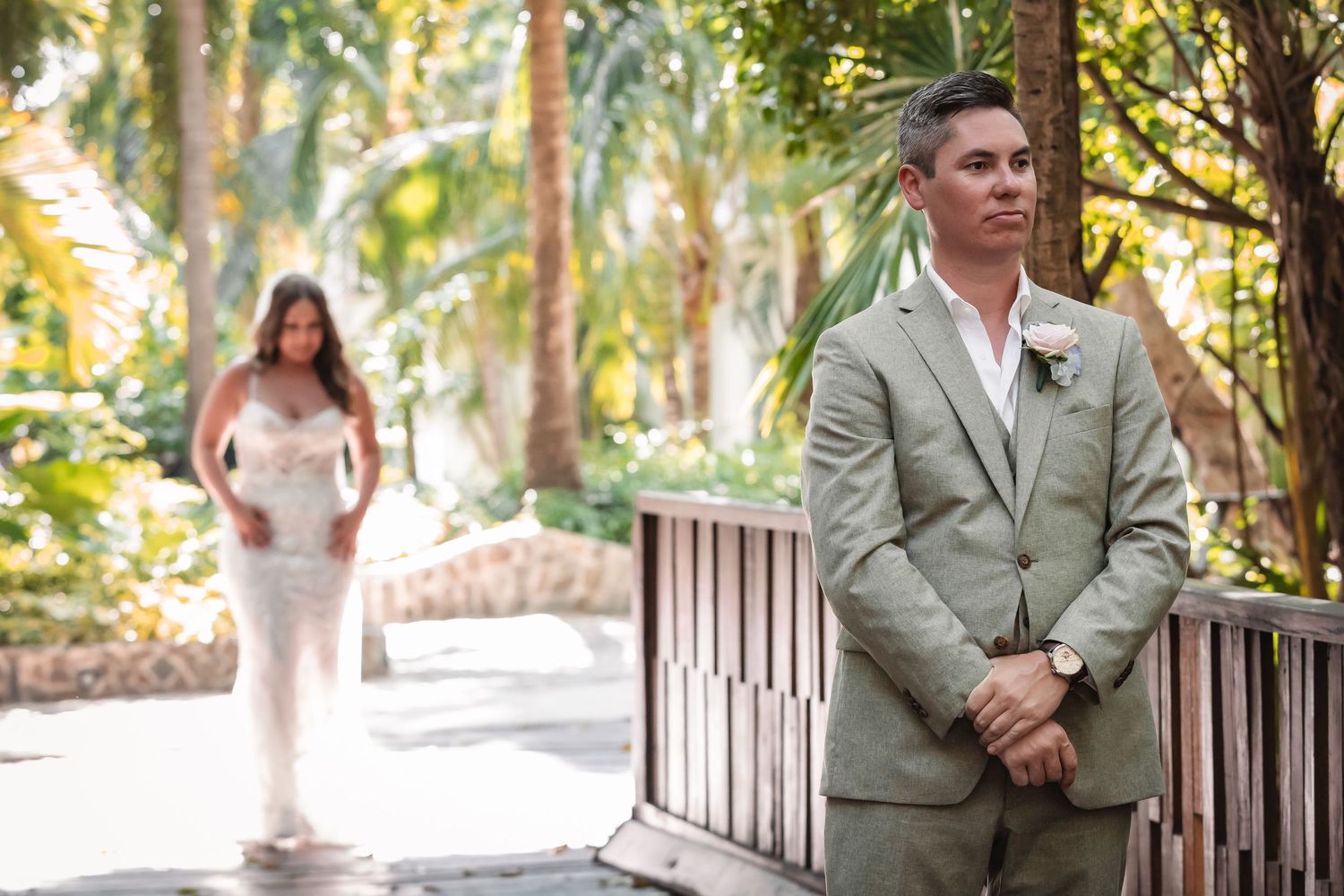 A romantic garden walkway with lush trees creates a natural wedding setting.