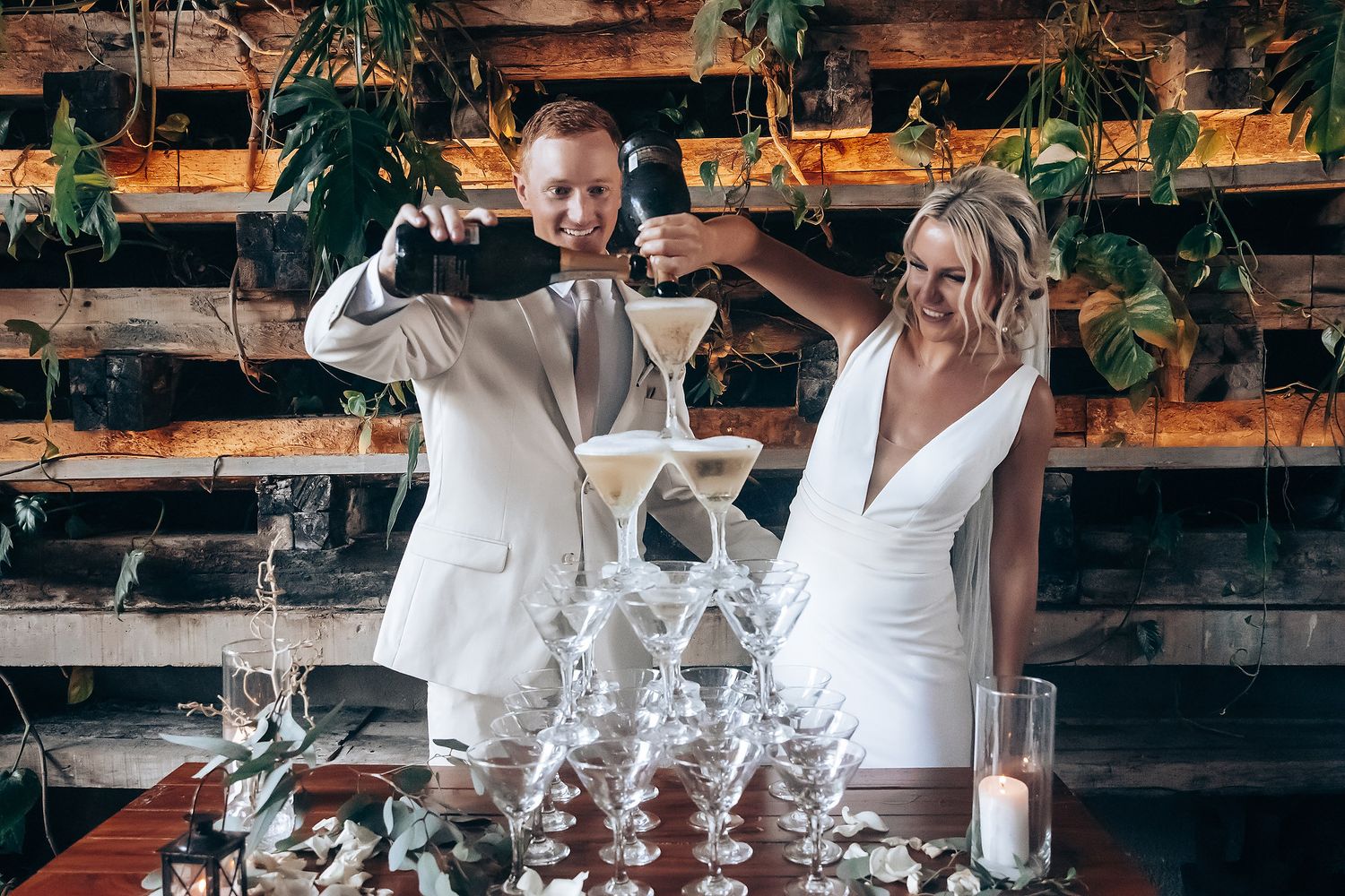 A celebratory moment with champagne glasses stacked in a pyramid at an elegant reception.