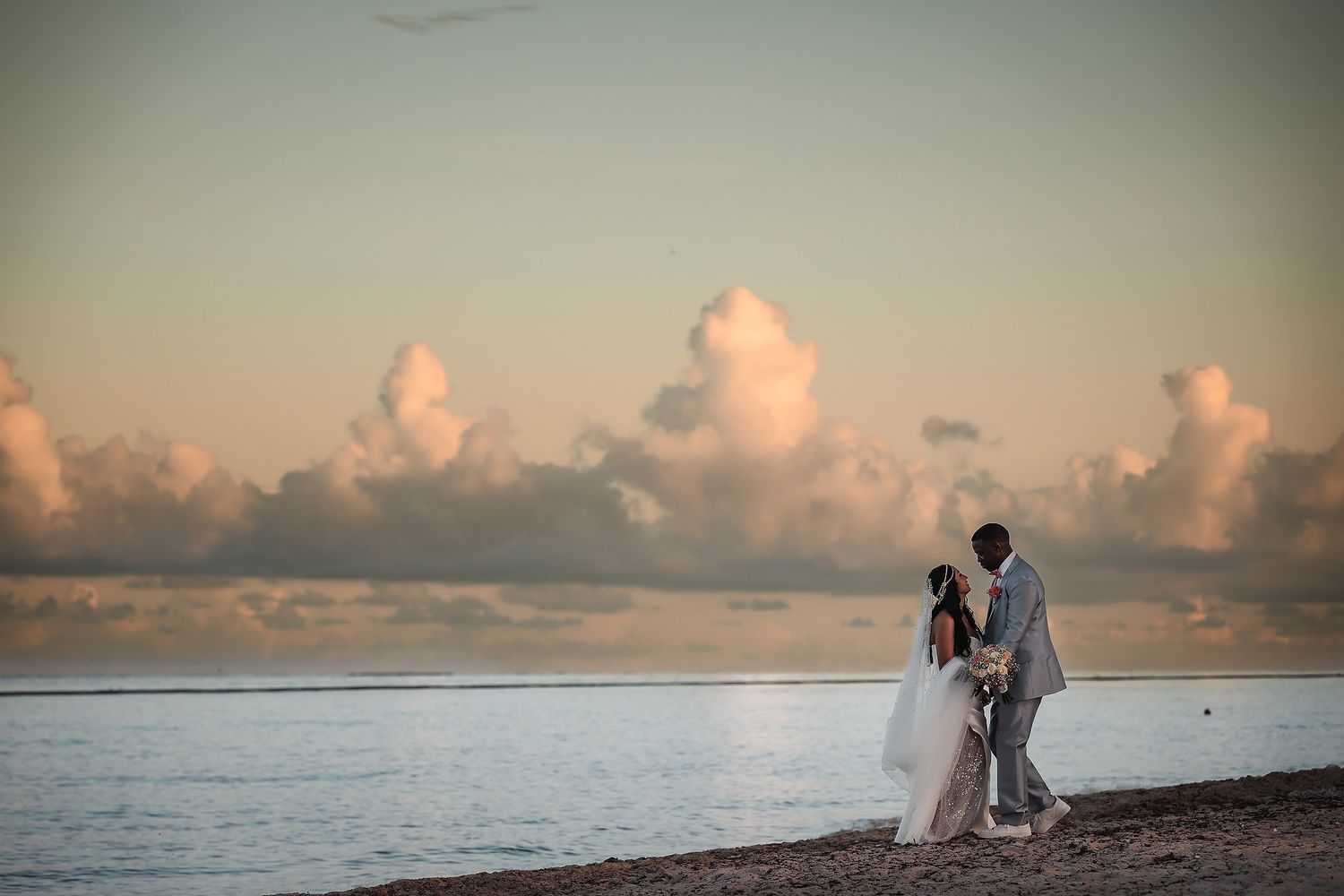 Wedding couple walking on the beach at Royalton Riviera Cancun