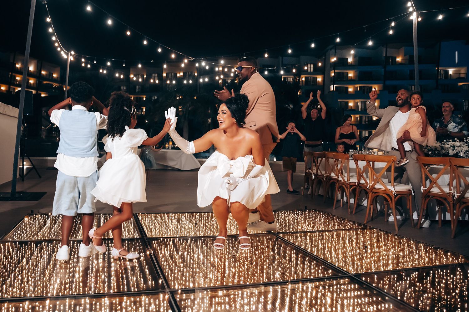 Festive outdoor celebration with string lights and sparklers creating a magical atmosphere.