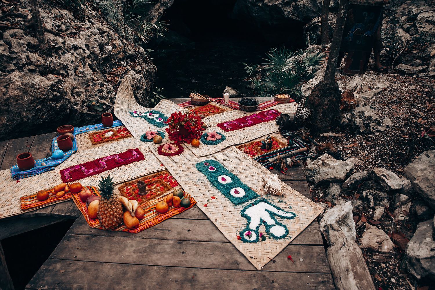 Colorful handmade kites with octopus and sea creature designs laid out on a rustic wooden surface outdoors.