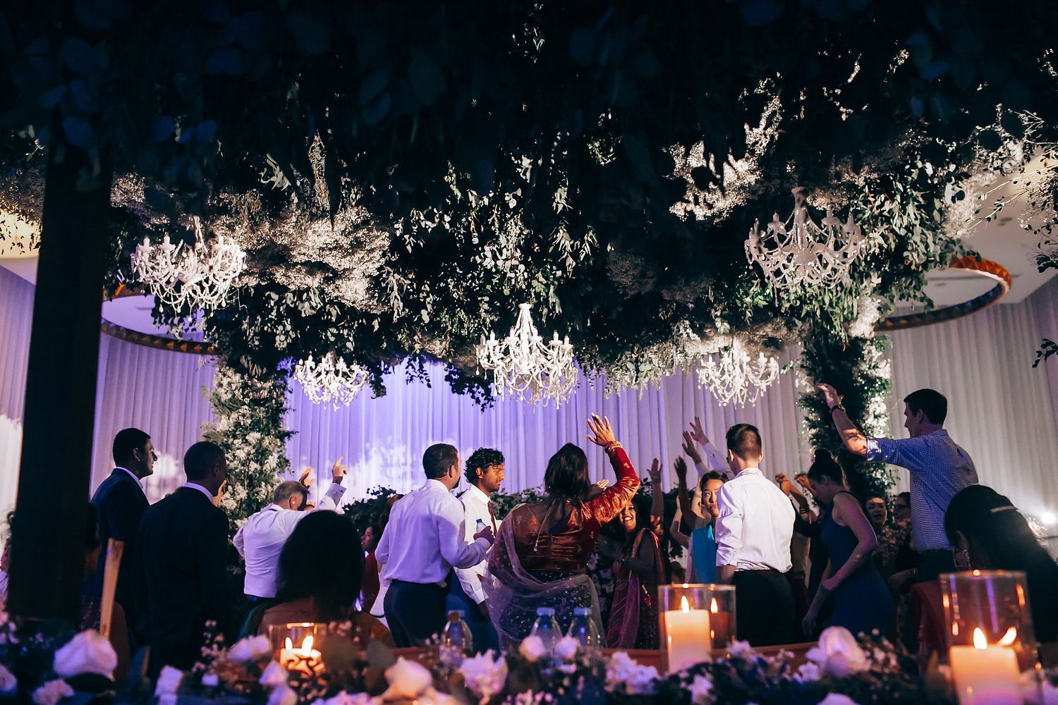 Evening wedding reception with ambient lighting and decorative elements.