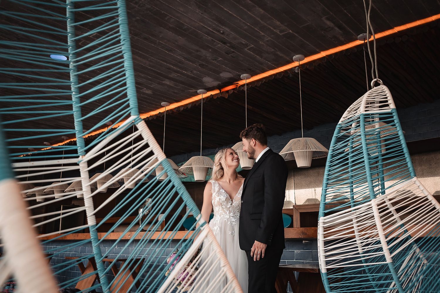 Artistic wedding photo sequence with modern architectural elements and dramatic lighting.