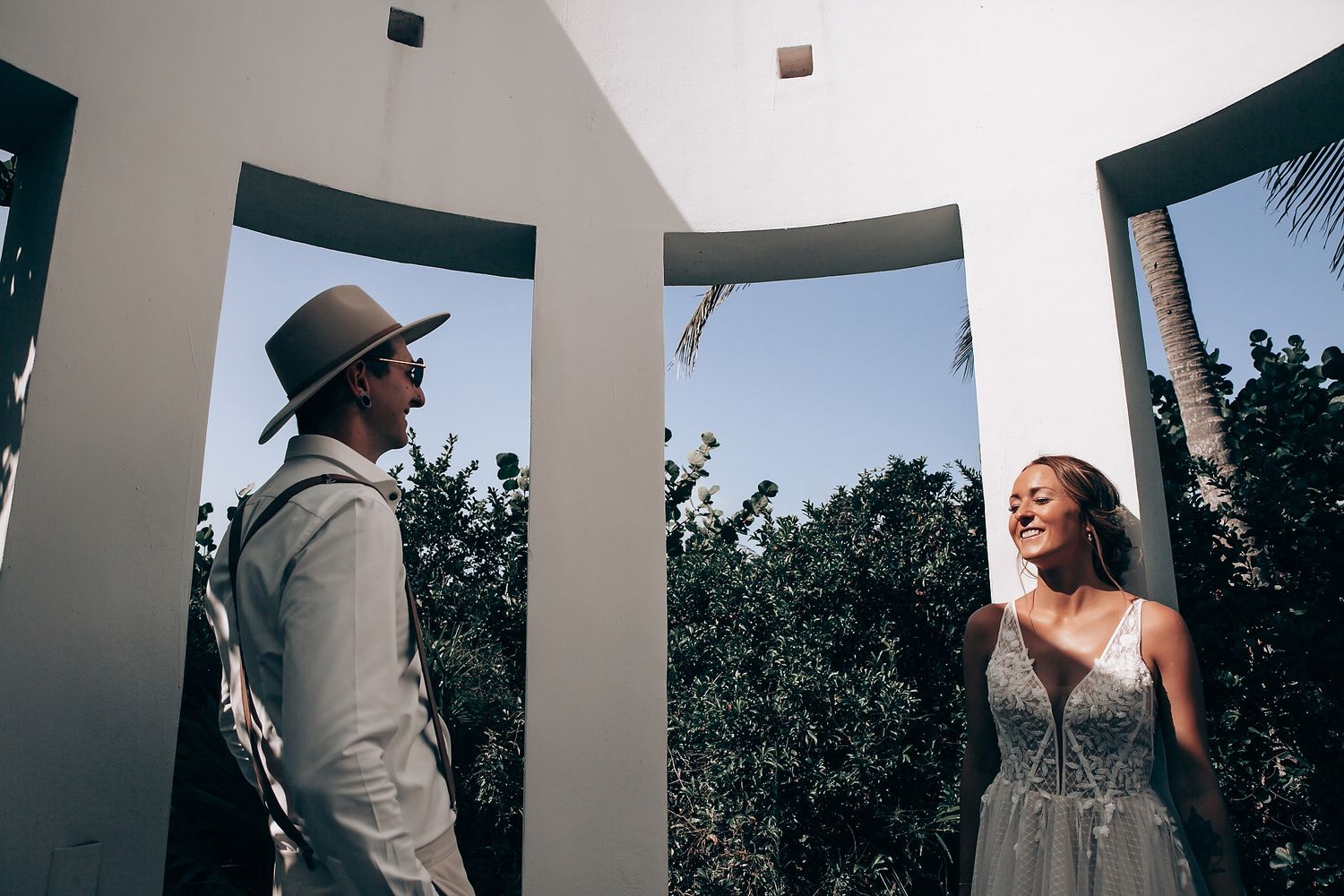 Wedding ceremony moments captured through architectural columns and pillars.