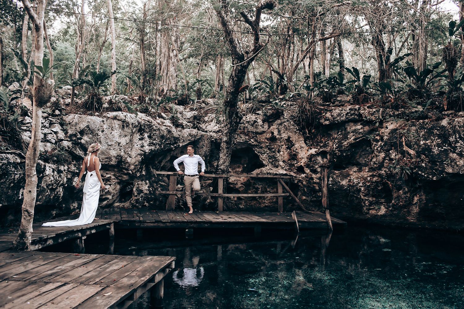 Panoramic view of a woodland wedding venue with wooden deck platform surrounded by natural forest scenery.