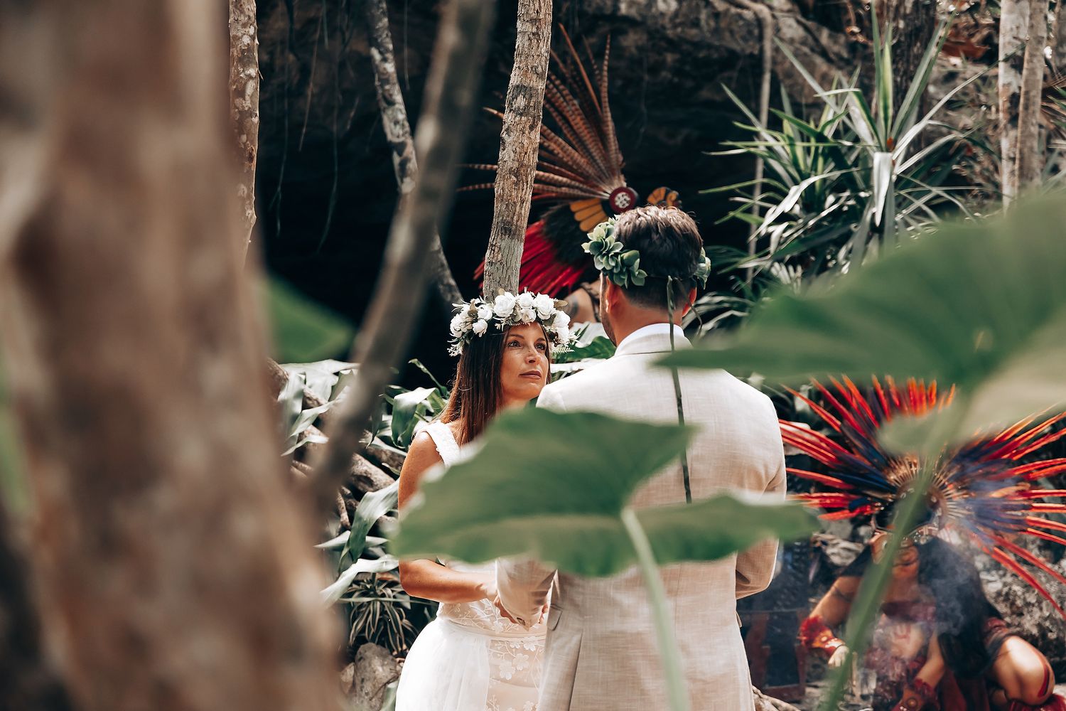 Tropical garden wedding ceremony setup with palm trees and natural decor in a lush outdoor setting.