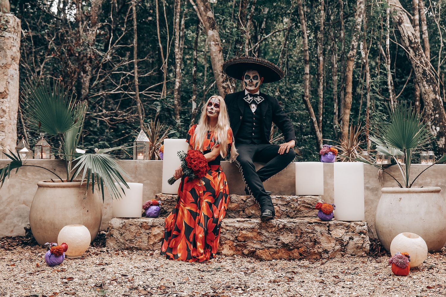 Gothic-styled outdoor scene with decorative elements including white candles and formal attire.