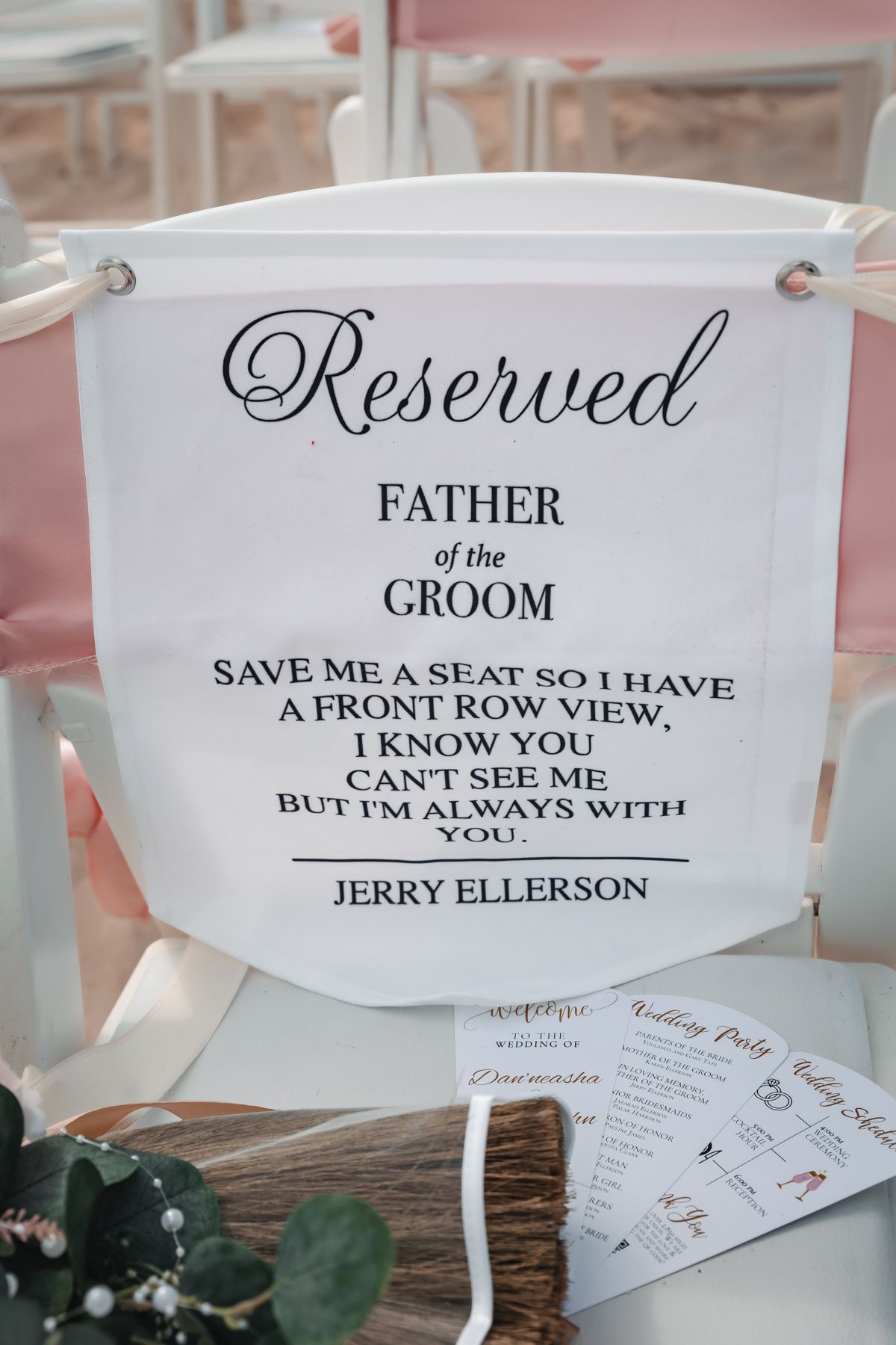 Reserved Father of the Groom memorial chair sign honoring Jerry Ellerson at a wedding ceremony.