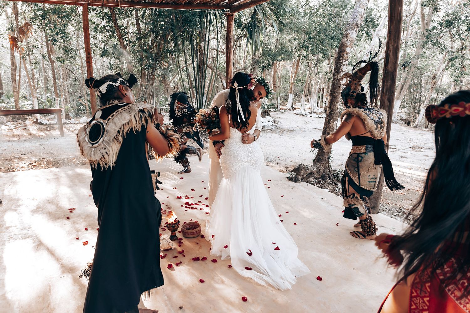 Celebration under a wooden pavilion with guests in formal attire.