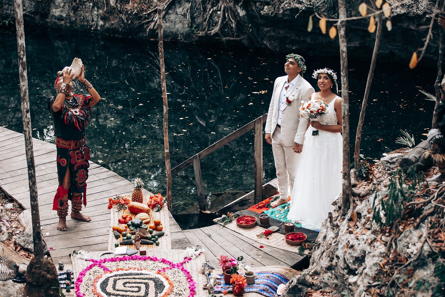 A traditional ceremony setup in a forest clearing with decorative elements and seating.