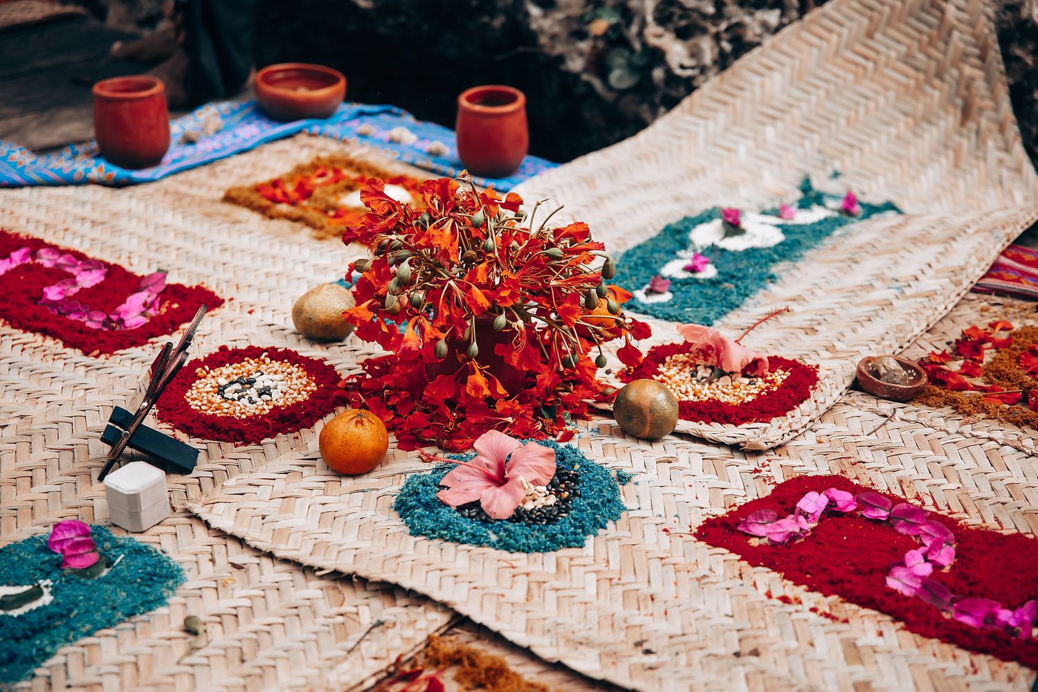 Colorful autumn table setting with red berries, woven placemats, and decorative pumpkins arranged in festive display.