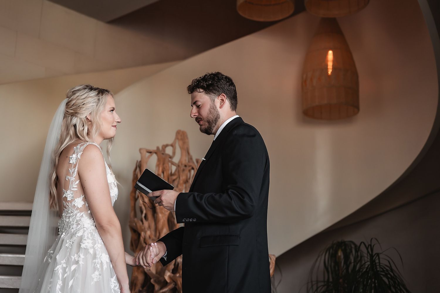 Emotional couple sharing private first look moment before their wedding ceremony.