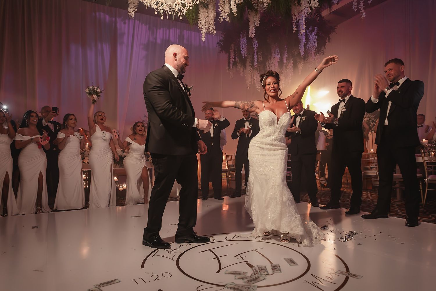 Elegant ballroom wedding reception with crystal chandeliers and dancing couples.