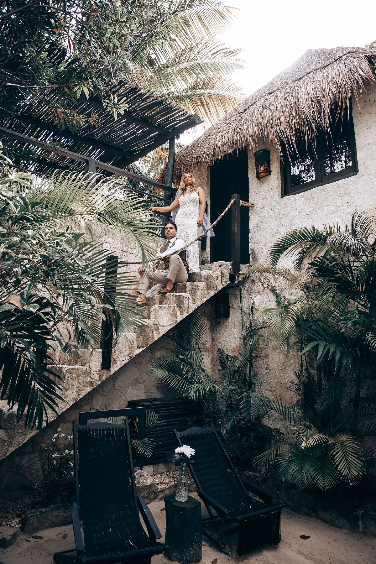 Wedding photo series showing moments on stone steps surrounded by lush tropical greenery.