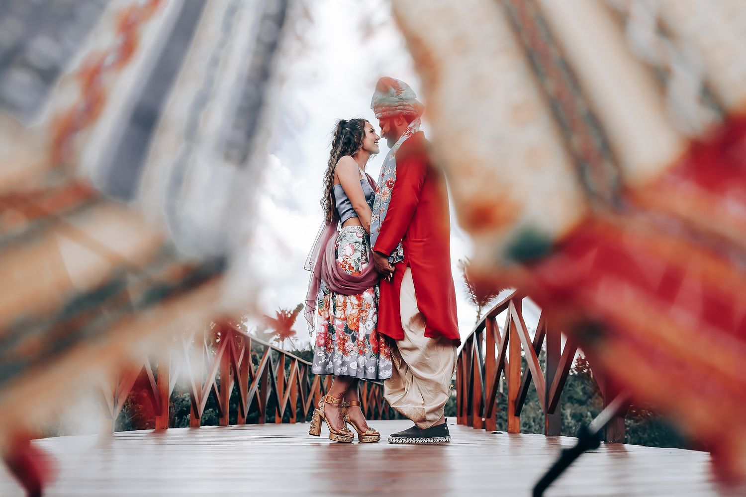 A couple walking together on a wooden boardwalk, captured in a romantic sequence of photos.