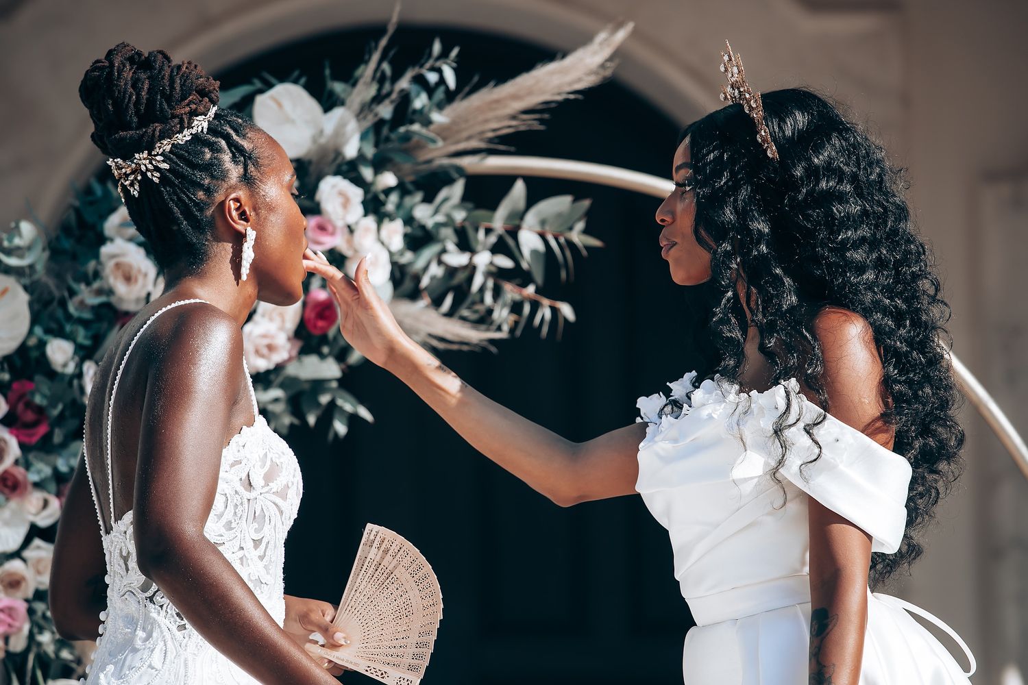 Romantic wedding moments captured against an ornate architectural backdrop with floral decor.