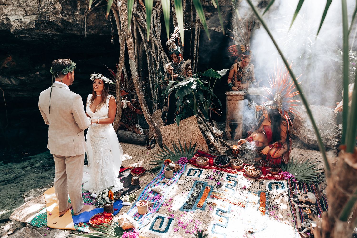 Traditional ceremony setup with colorful decorations under tropical palm trees.