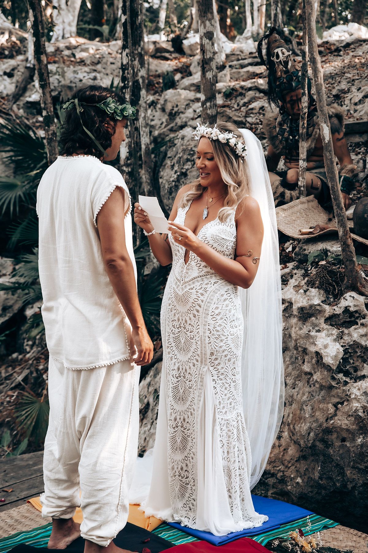 A series of intimate moments captured in white attire against a natural rocky backdrop during a ceremony.