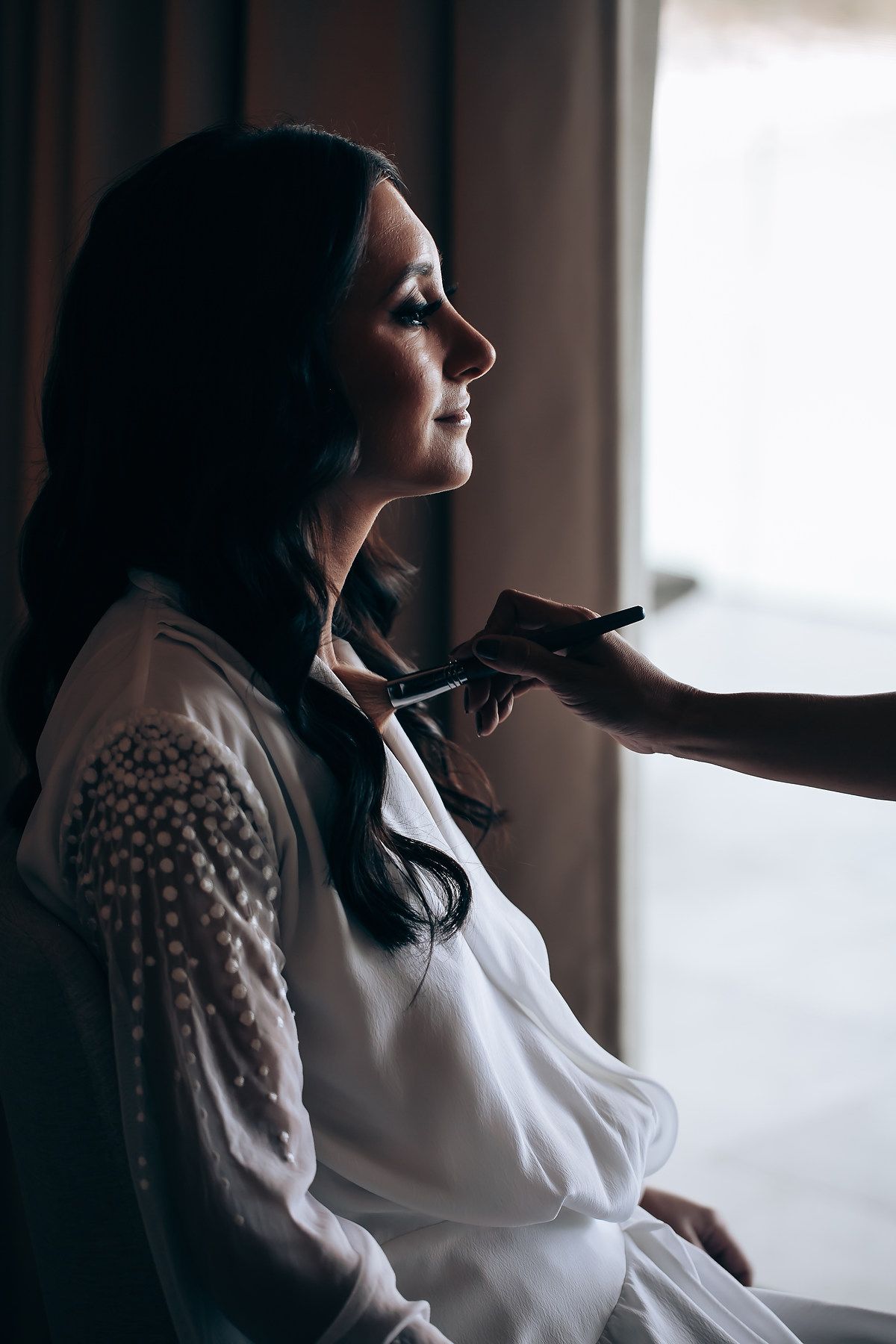 Silhouette profile shots of someone in a white blouse against a bright window.