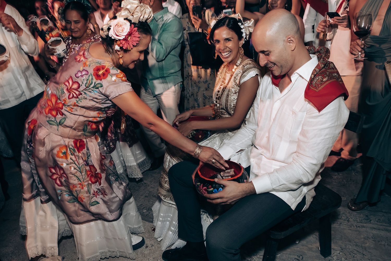 Wedding guests dancing and celebrating at a lively reception party.