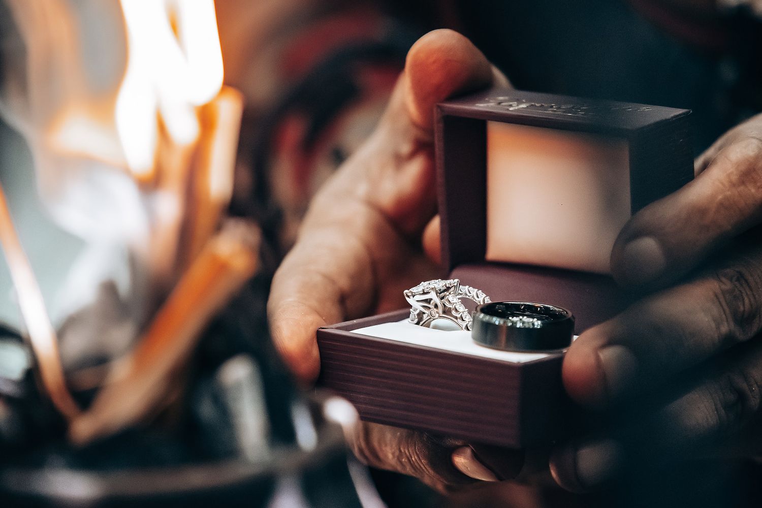 Close-up shot of hands exchanging wedding rings during ceremony.