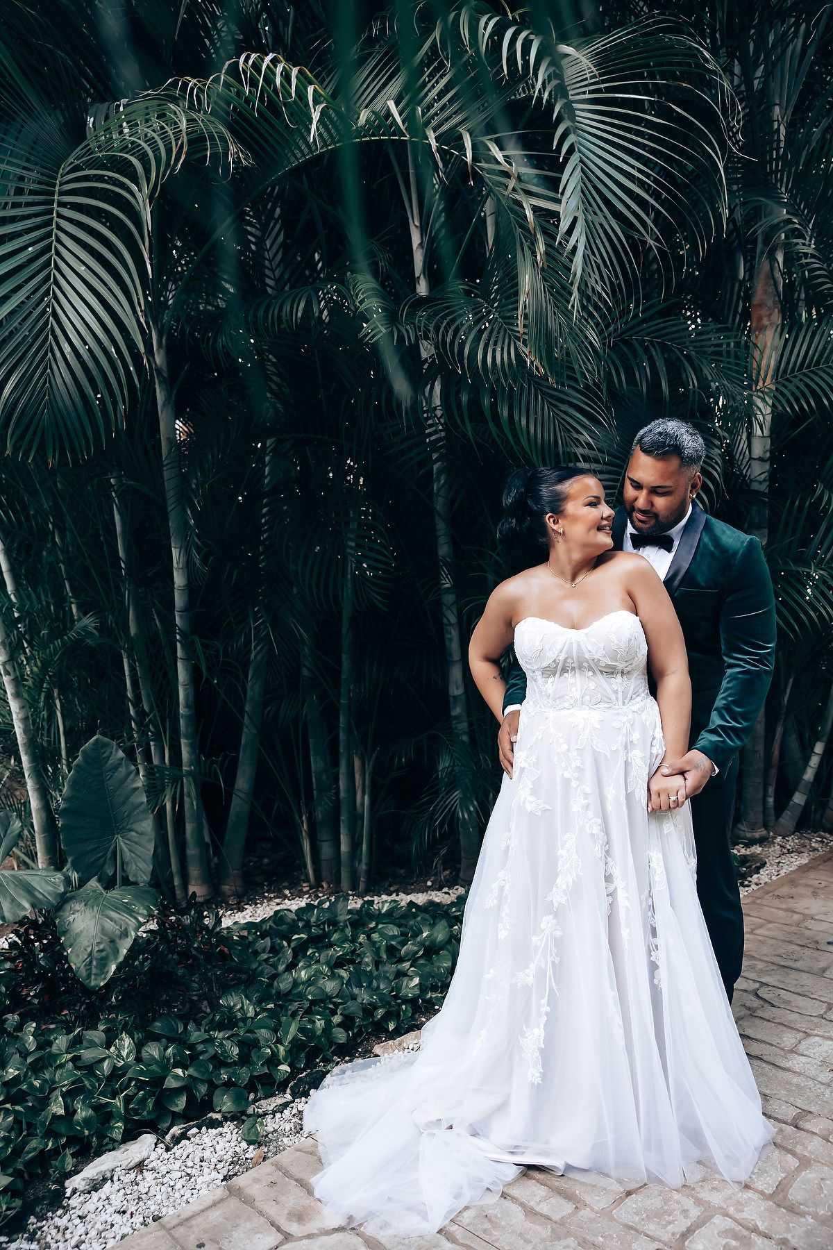 Romantic wedding photography in a tropical palm garden setting.